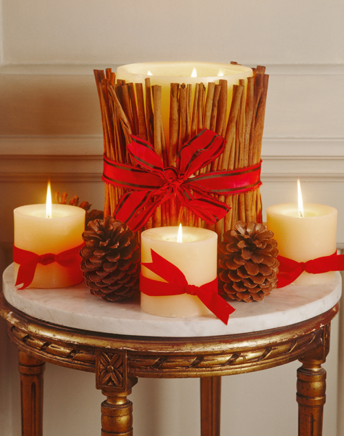 christmas-centerpieces-pillar-candles-red-ribbons-cinnamon-sticks